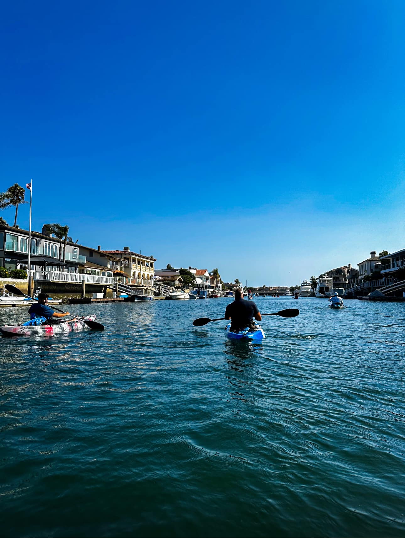 Group kayaking through harbor