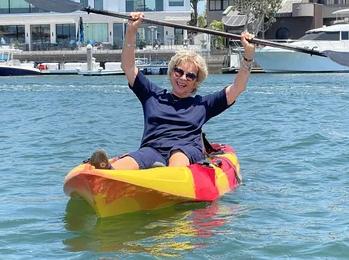 Kid celebrating kayak success