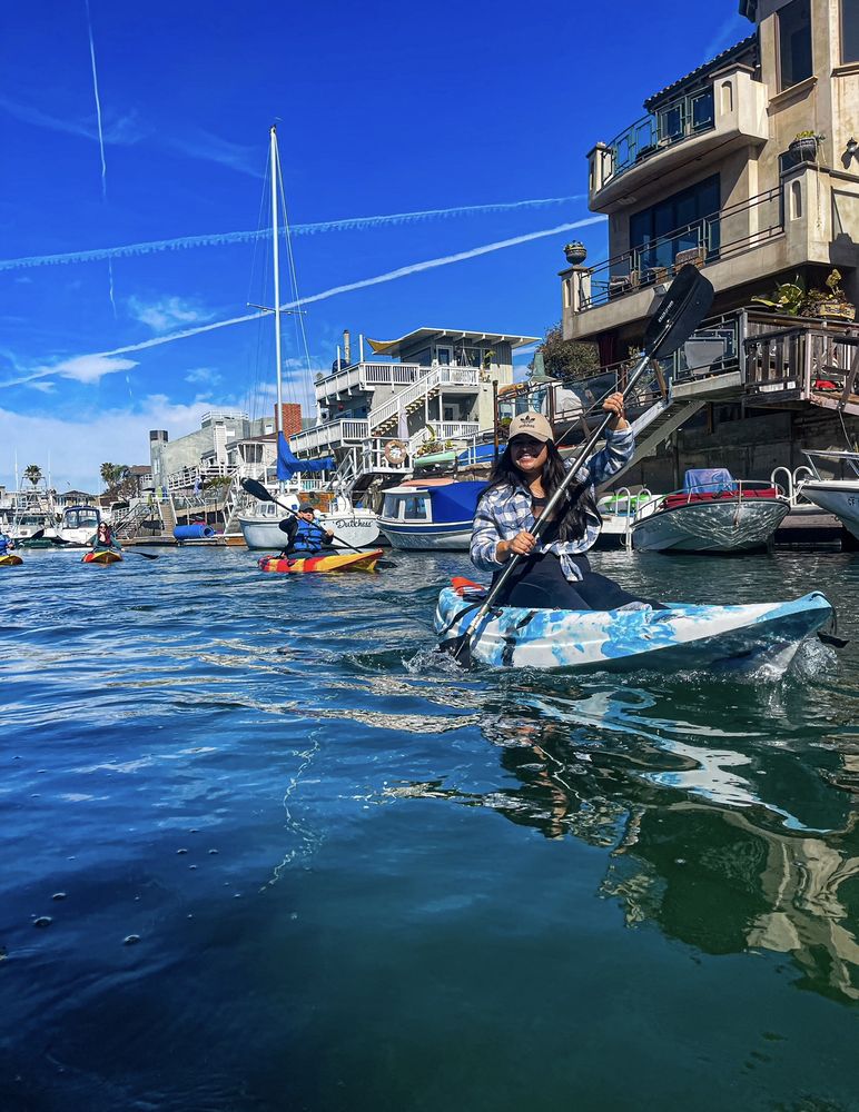 Kayaking past boats