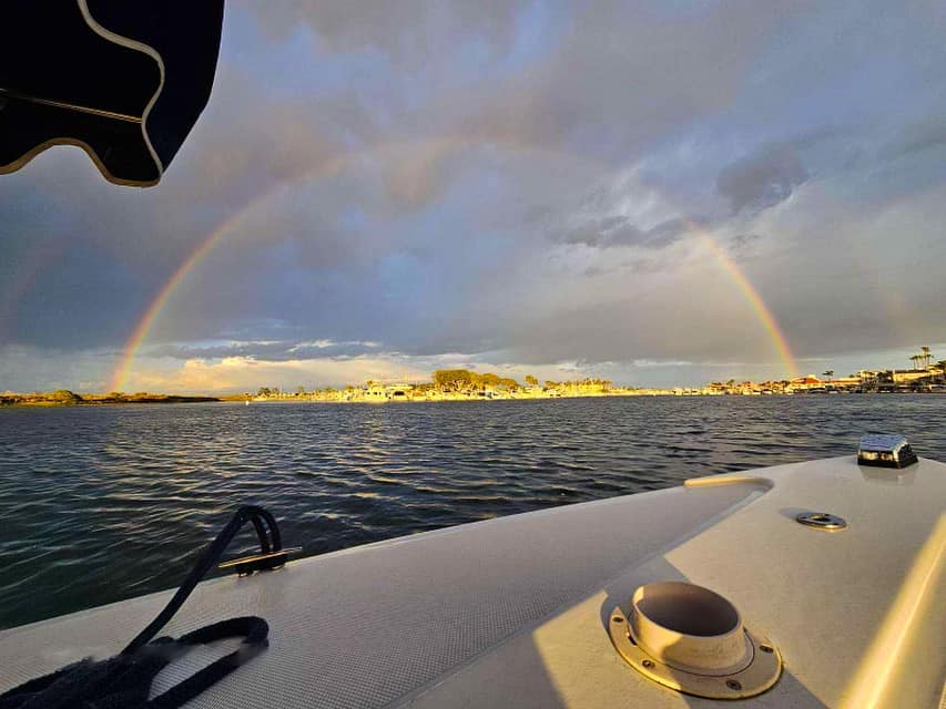 Harbor with boats and rainbow