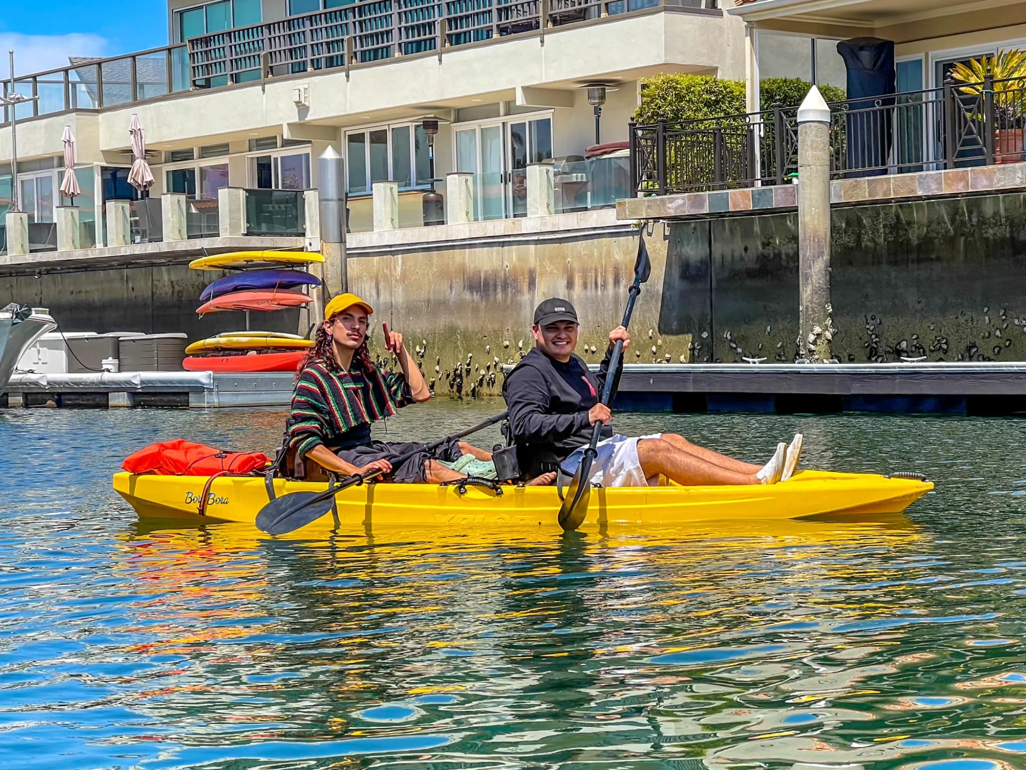 Kayakers paddling past waterfront homes